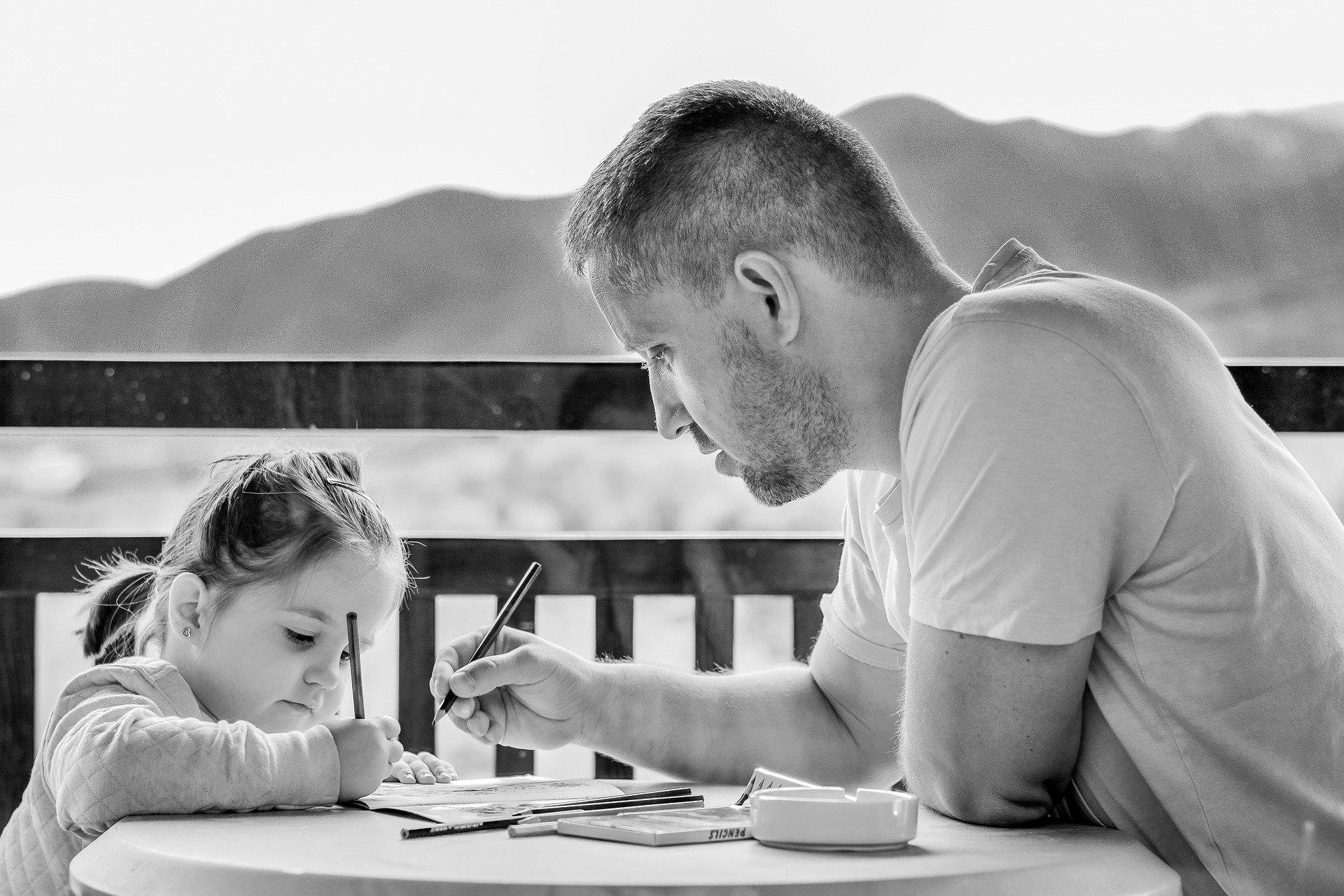 daughter writing with her father