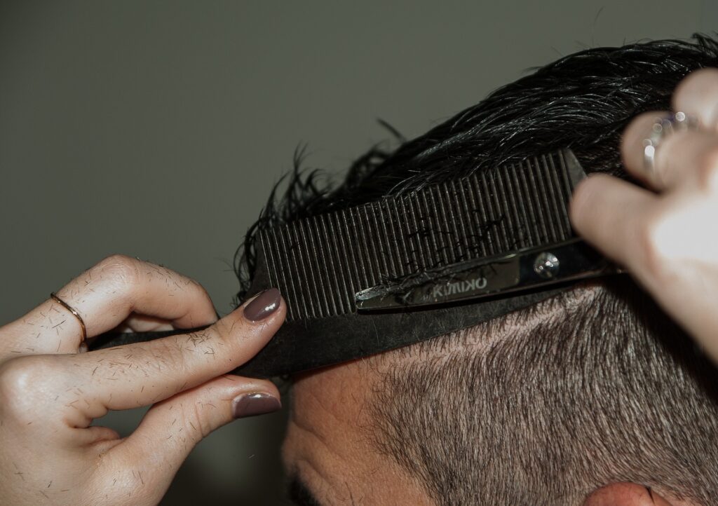 close up of guy getting his hair cut short