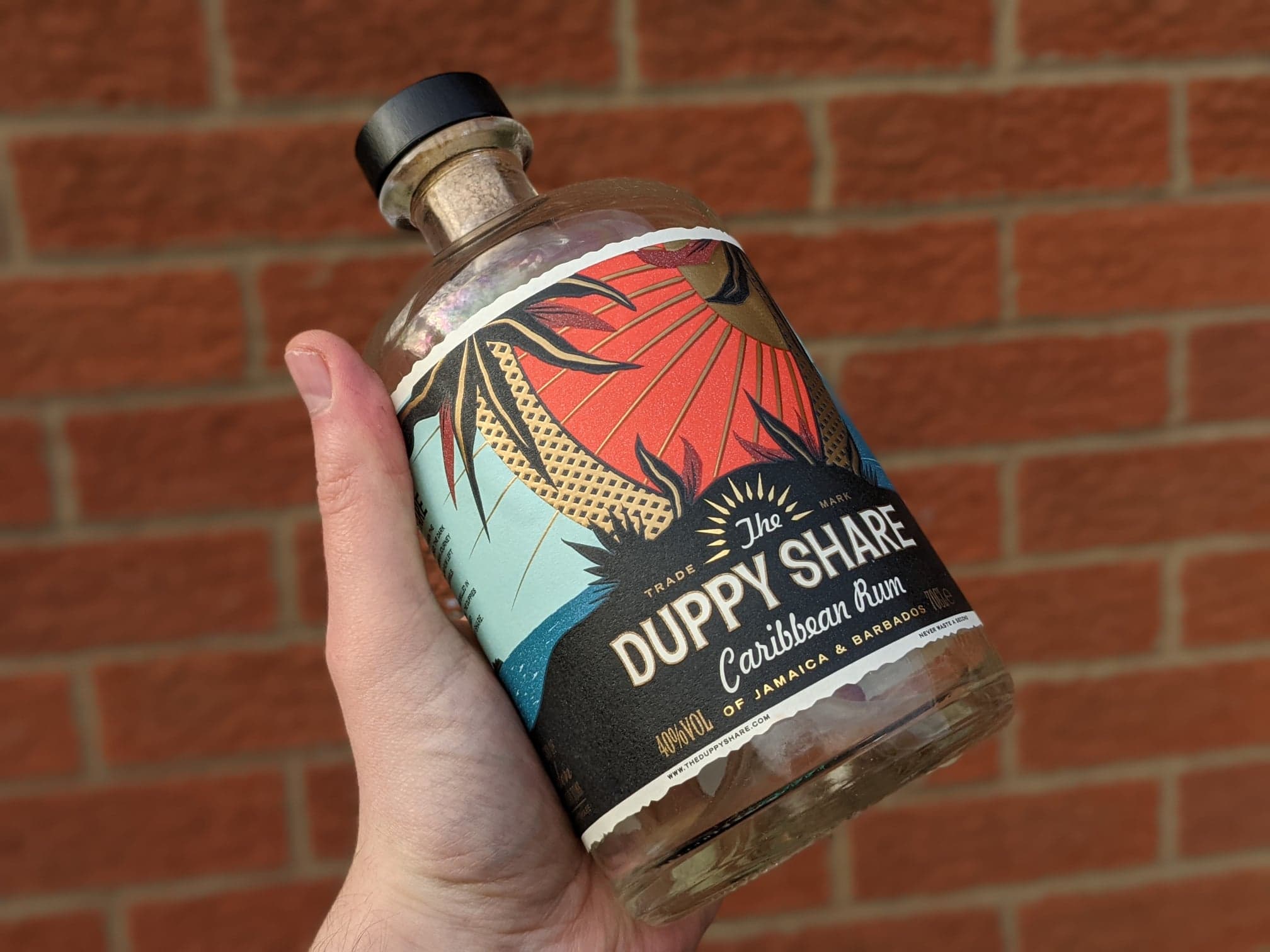 holding empty duppy share bottle