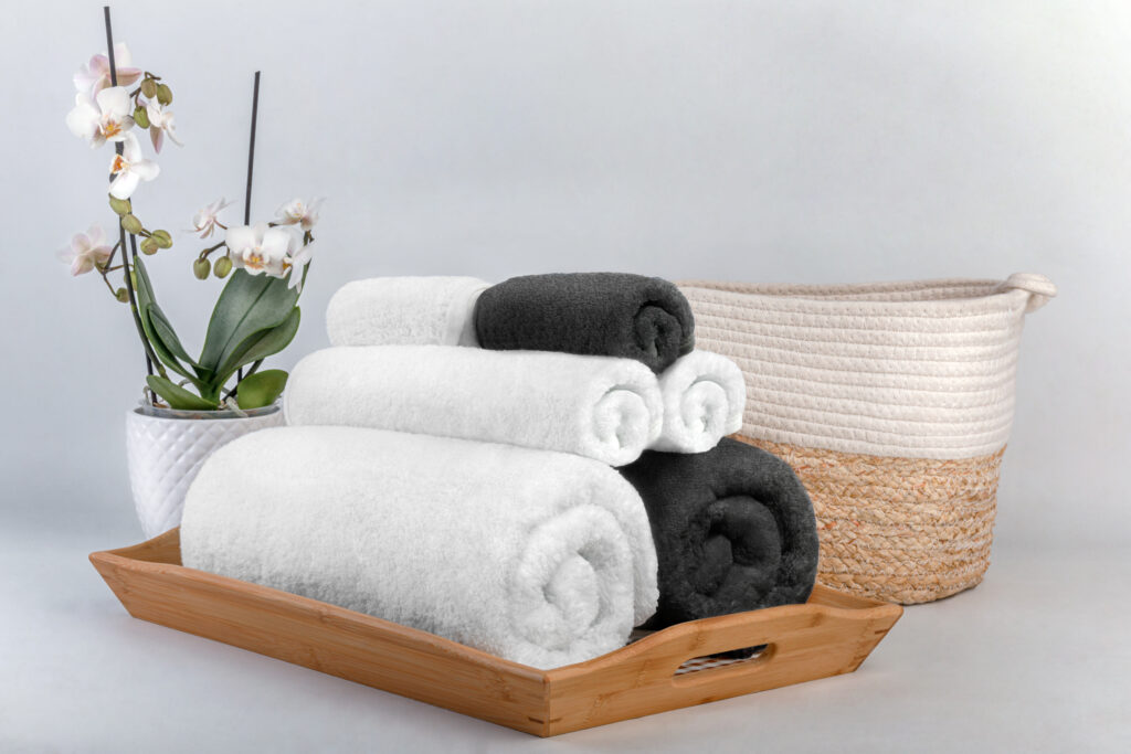 soji towels stacked up in rolls on bed