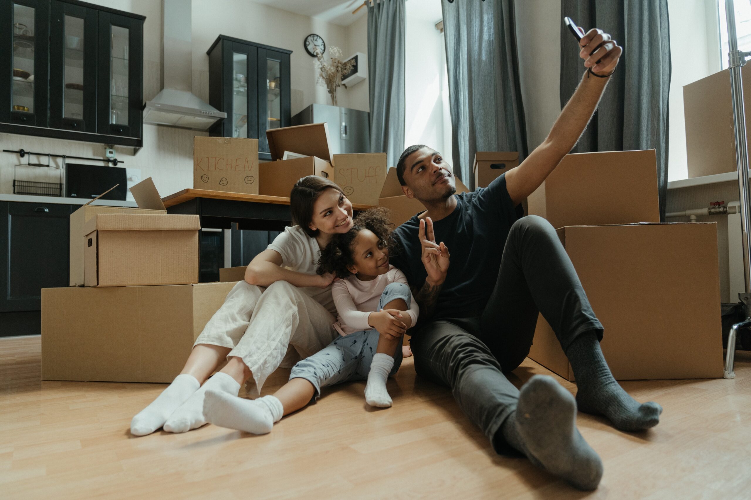 family with lots of boxes taking a selfie