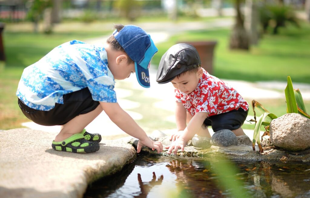 2 kids playing in puddle