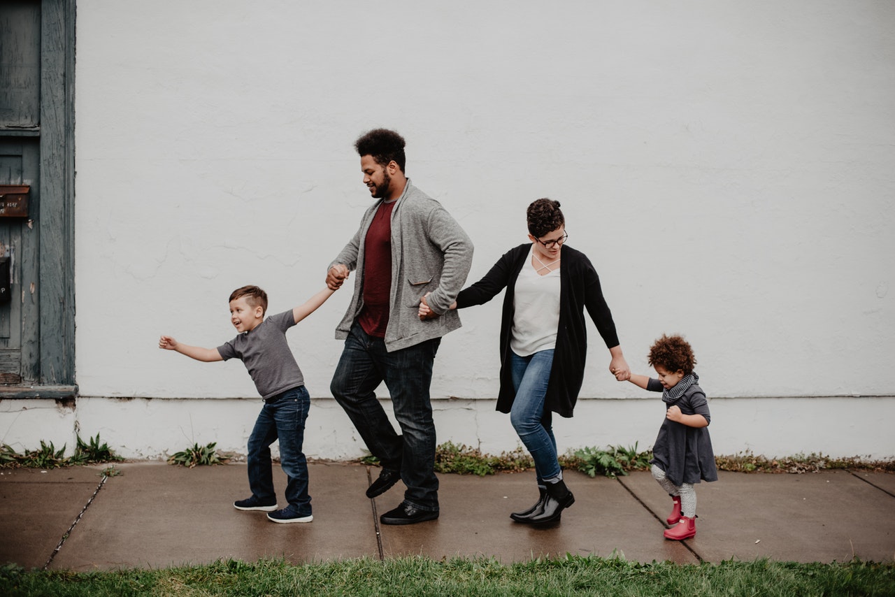 family walking down wet pavement