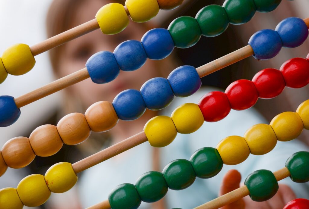 close up of abacus with child behind it