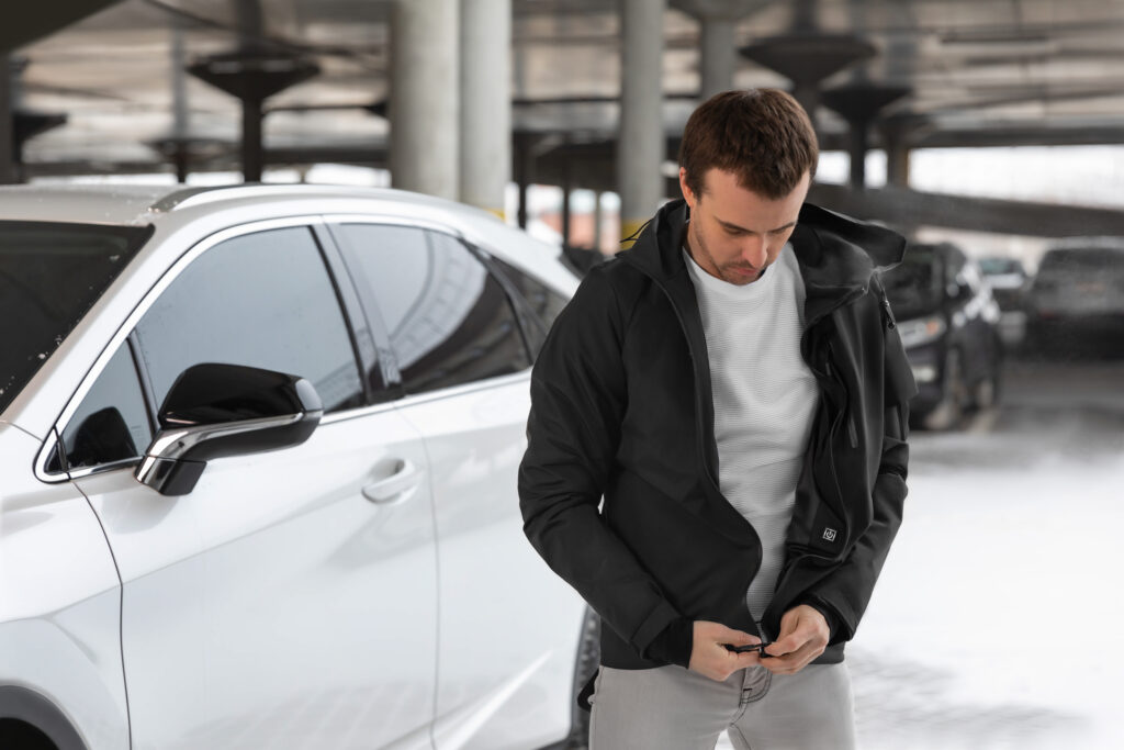 guy in jacket next to car
