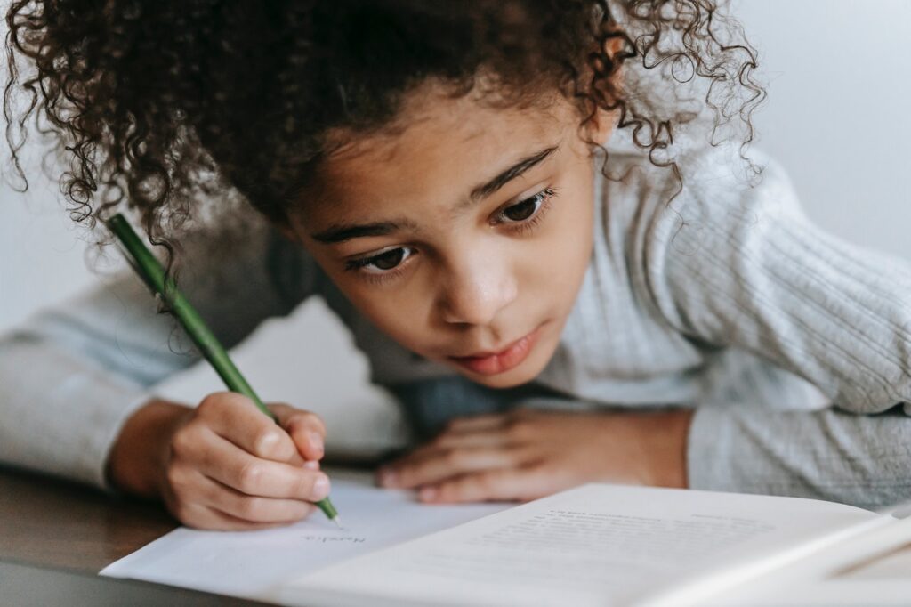young girl writing