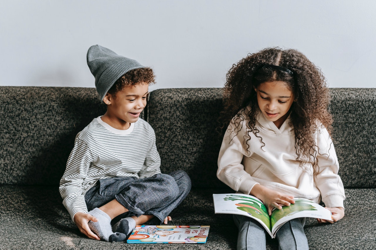 two kids reading a book