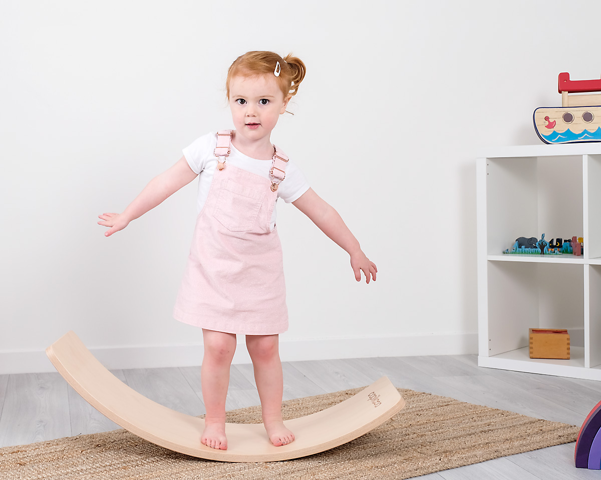 kid on a wooden toy thing