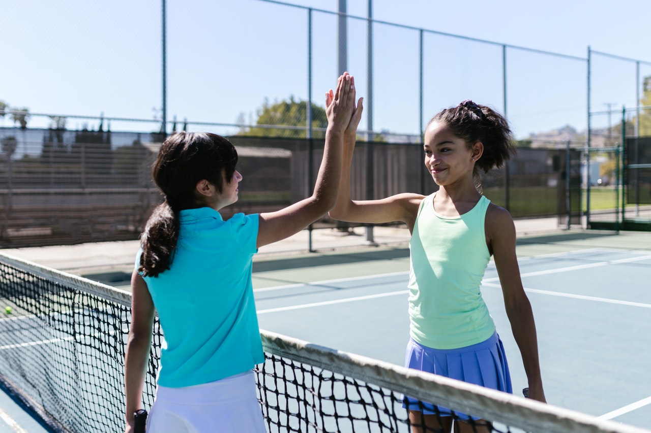 two girls on tennis court