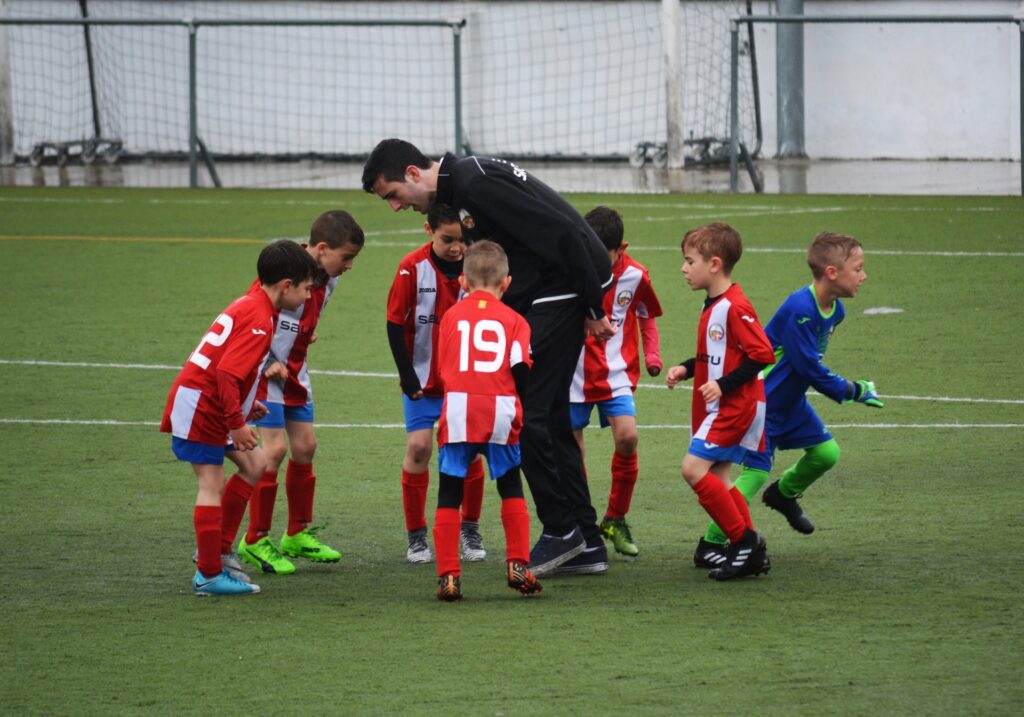 coach with kids football team