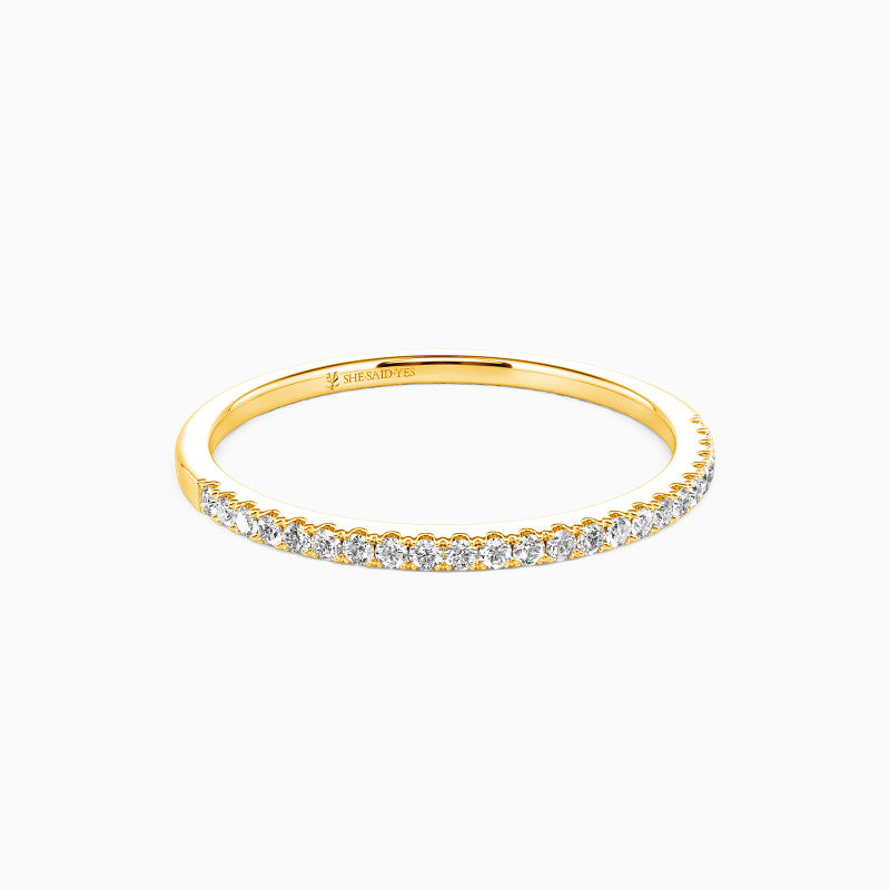 moissanite wedding ring. a simple gold band studded with jewels