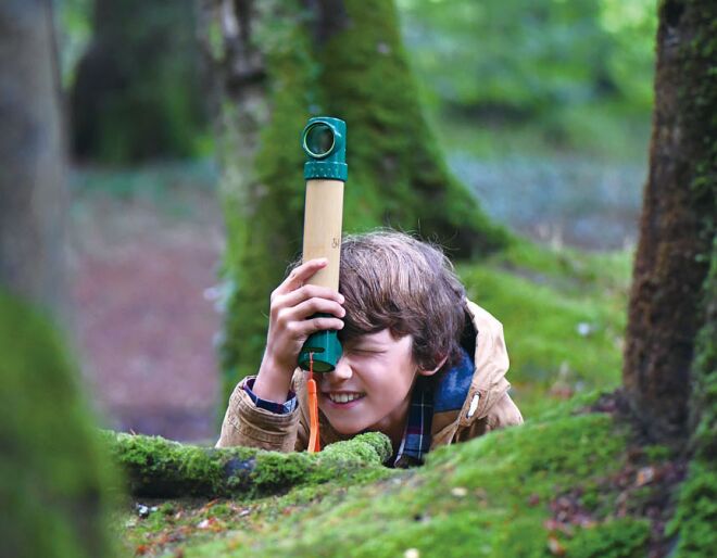 kid hiding behind log with periscope
