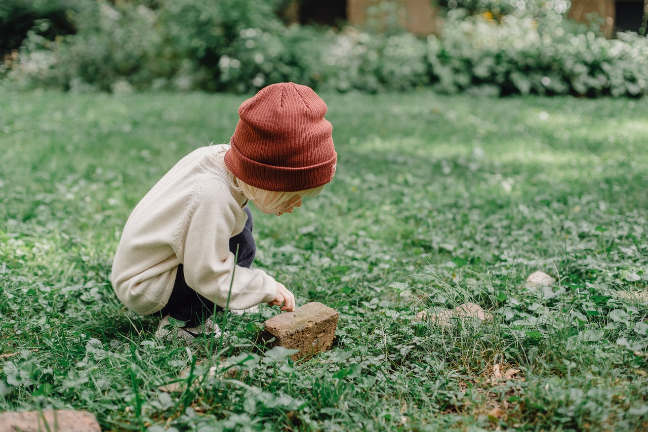 kid looking at grass