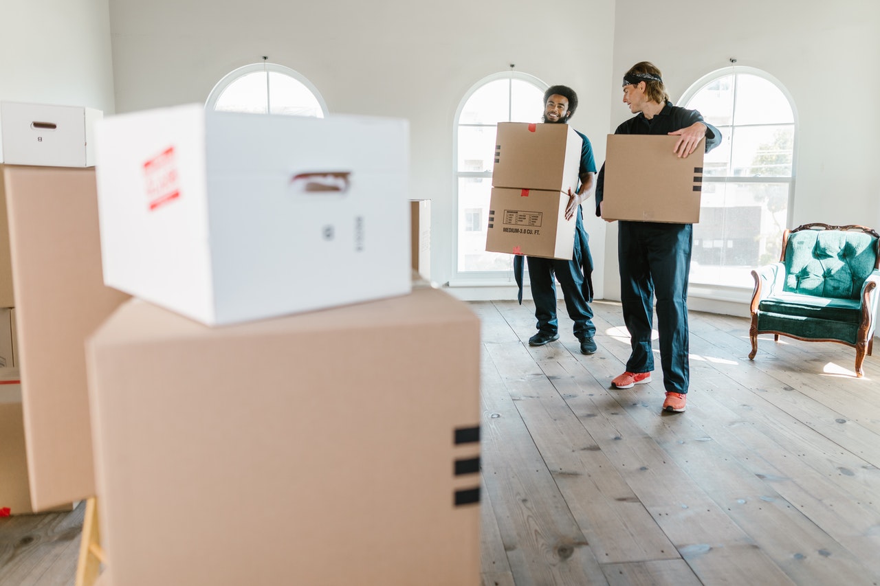 two blokes shifting boxes