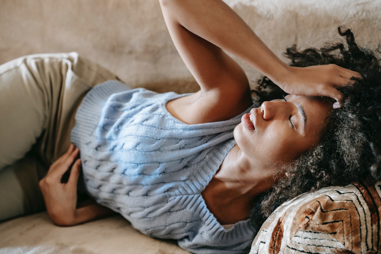 woman on couch with headache