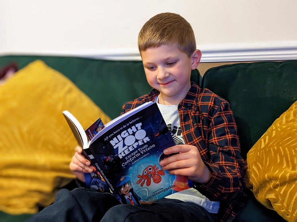 my son looking chuffed with his book