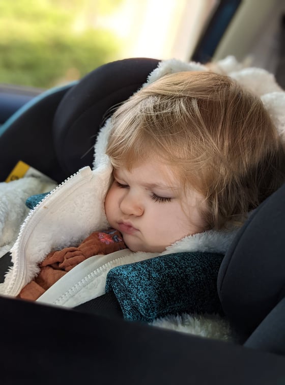 My daughter sleeping in her car seat.