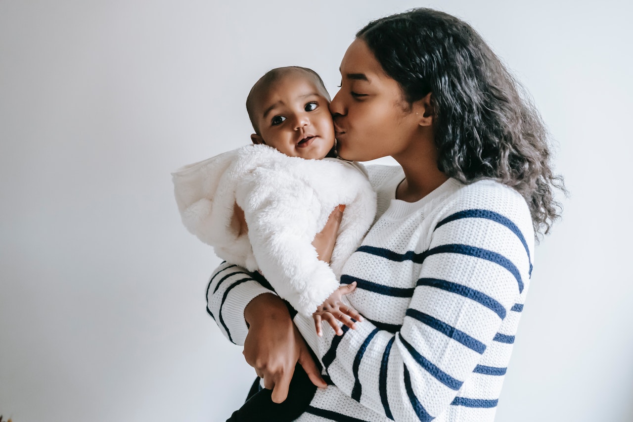 mother kissing baby