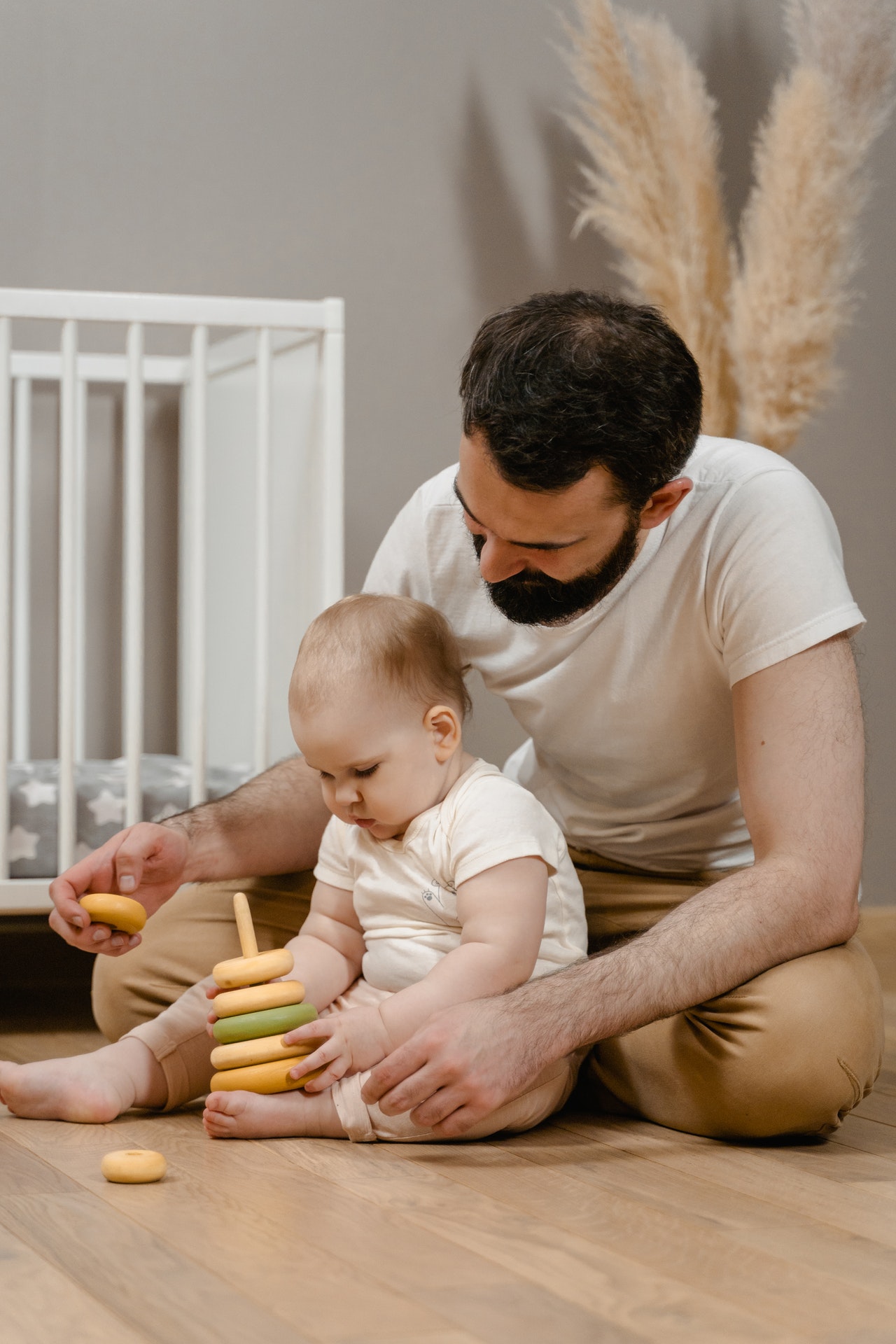 father and toddler playing