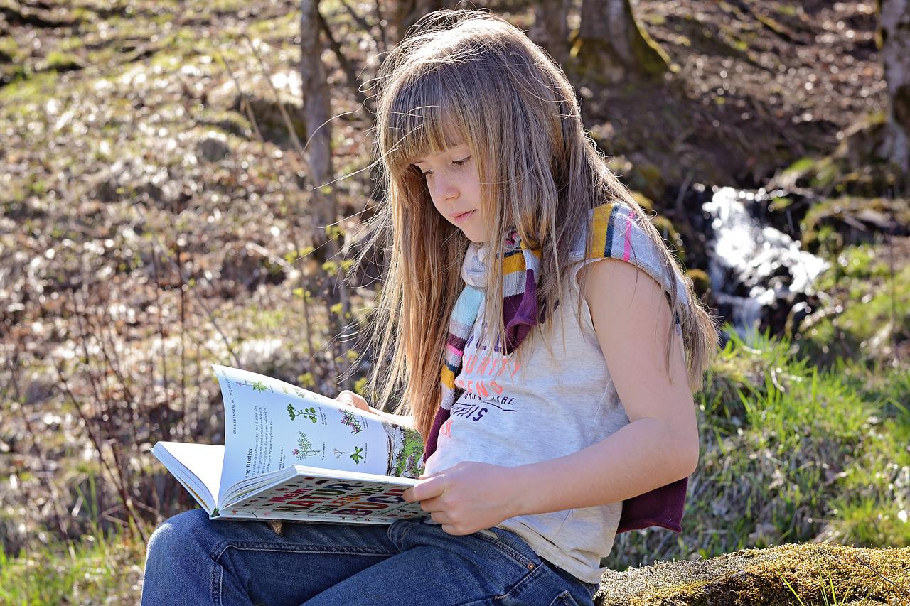 girl reading outside