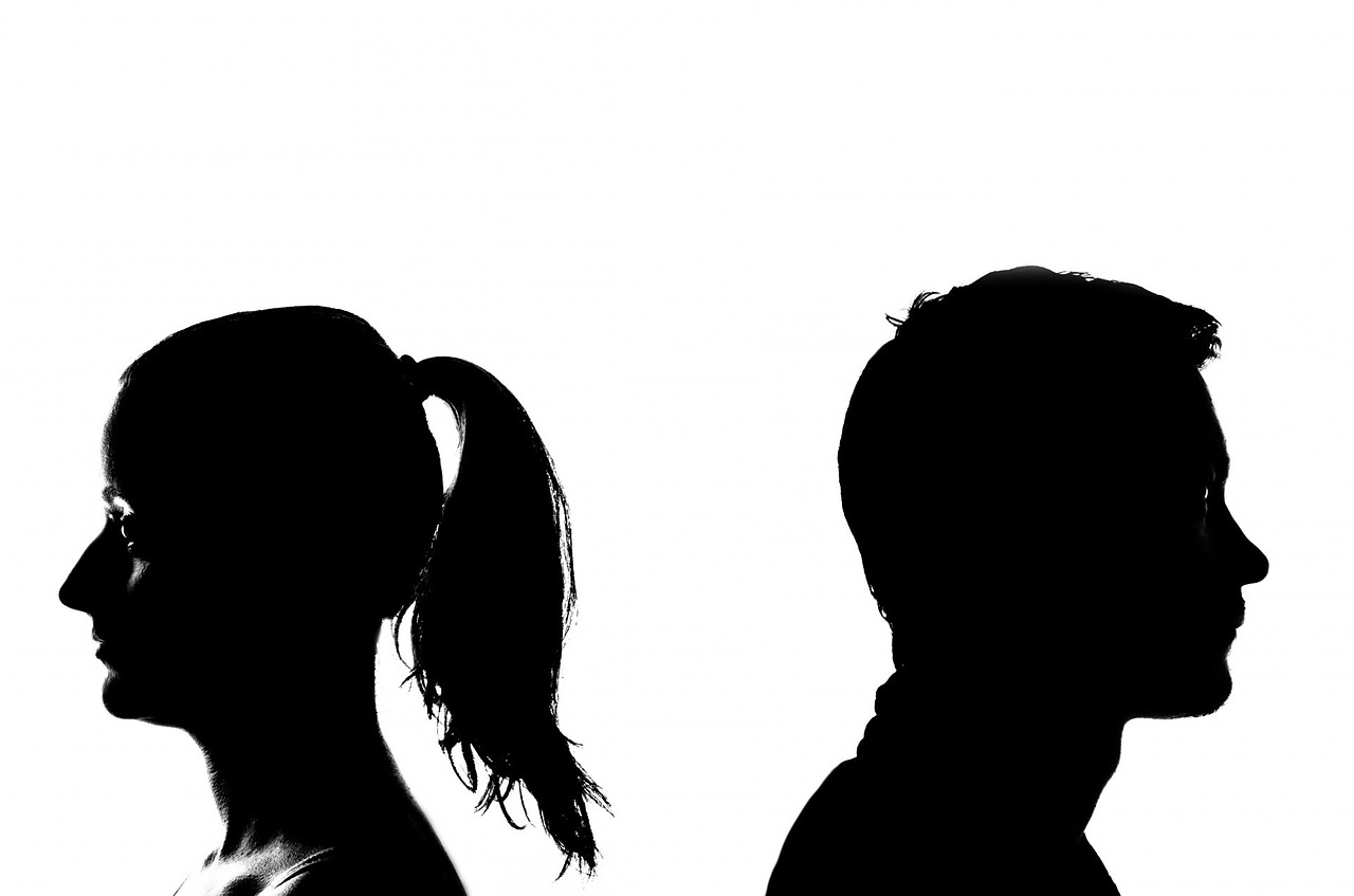 silhouette of man and woman with back to each other
