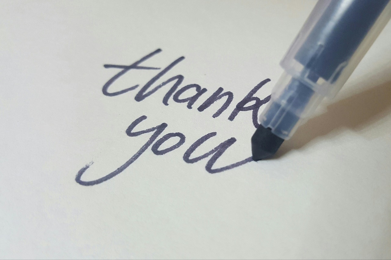 a pen writing 'thank you'