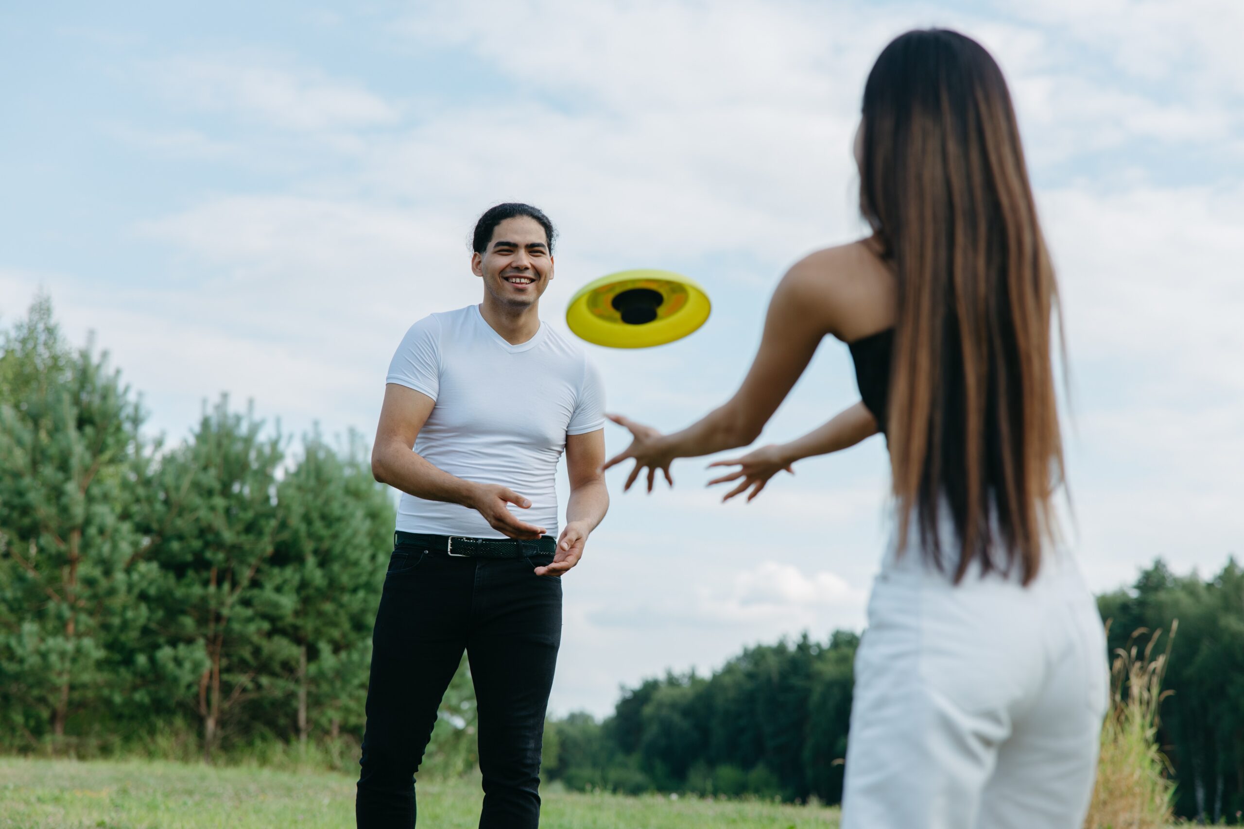 couple playing frisbee. the idealactivity for sweat proof t shirts