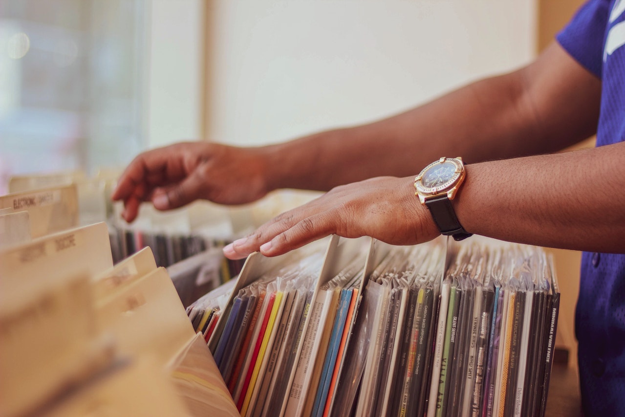 guy flicking through records in a shop