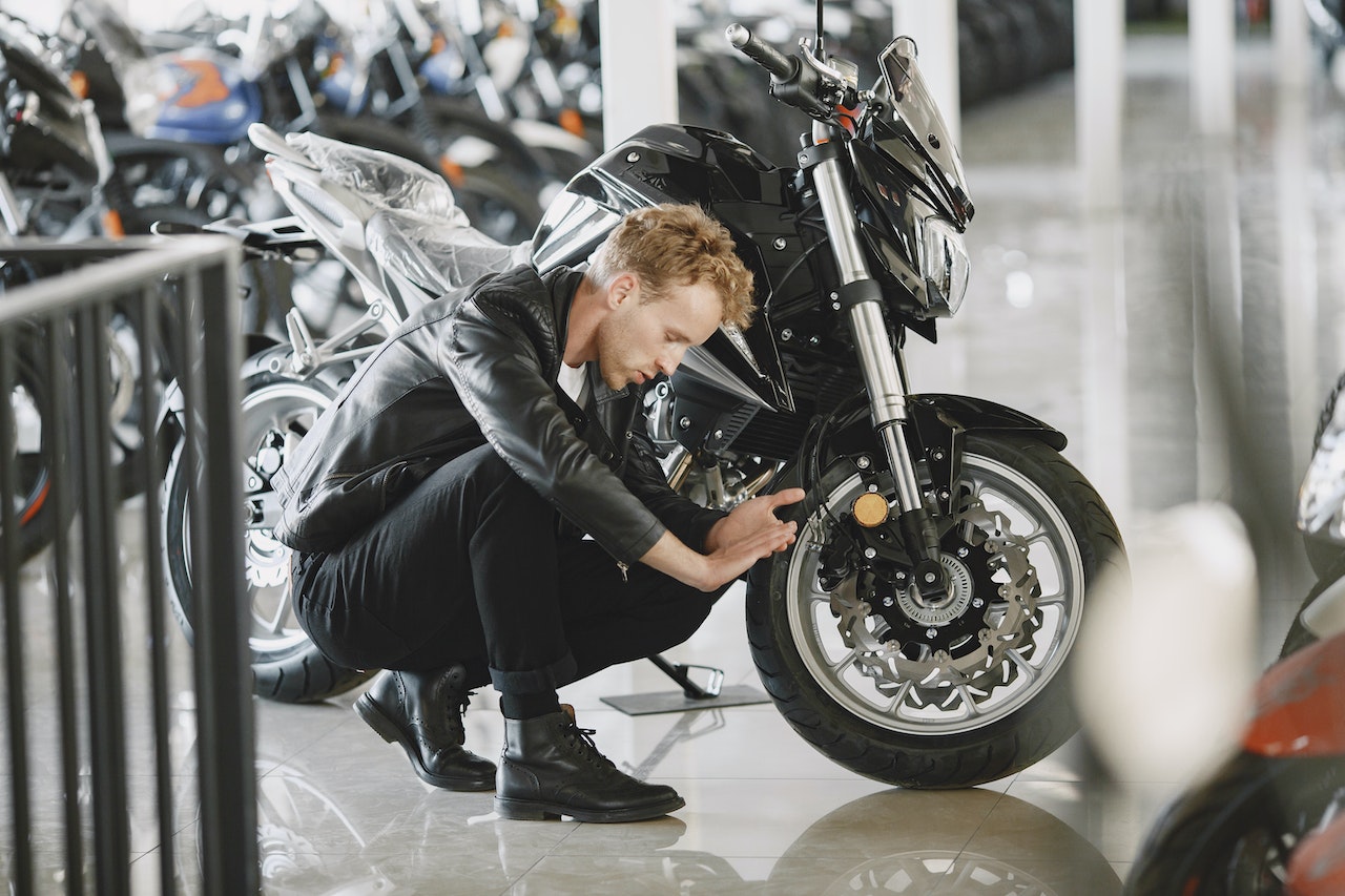 guy looking a little too lovingly at his bike