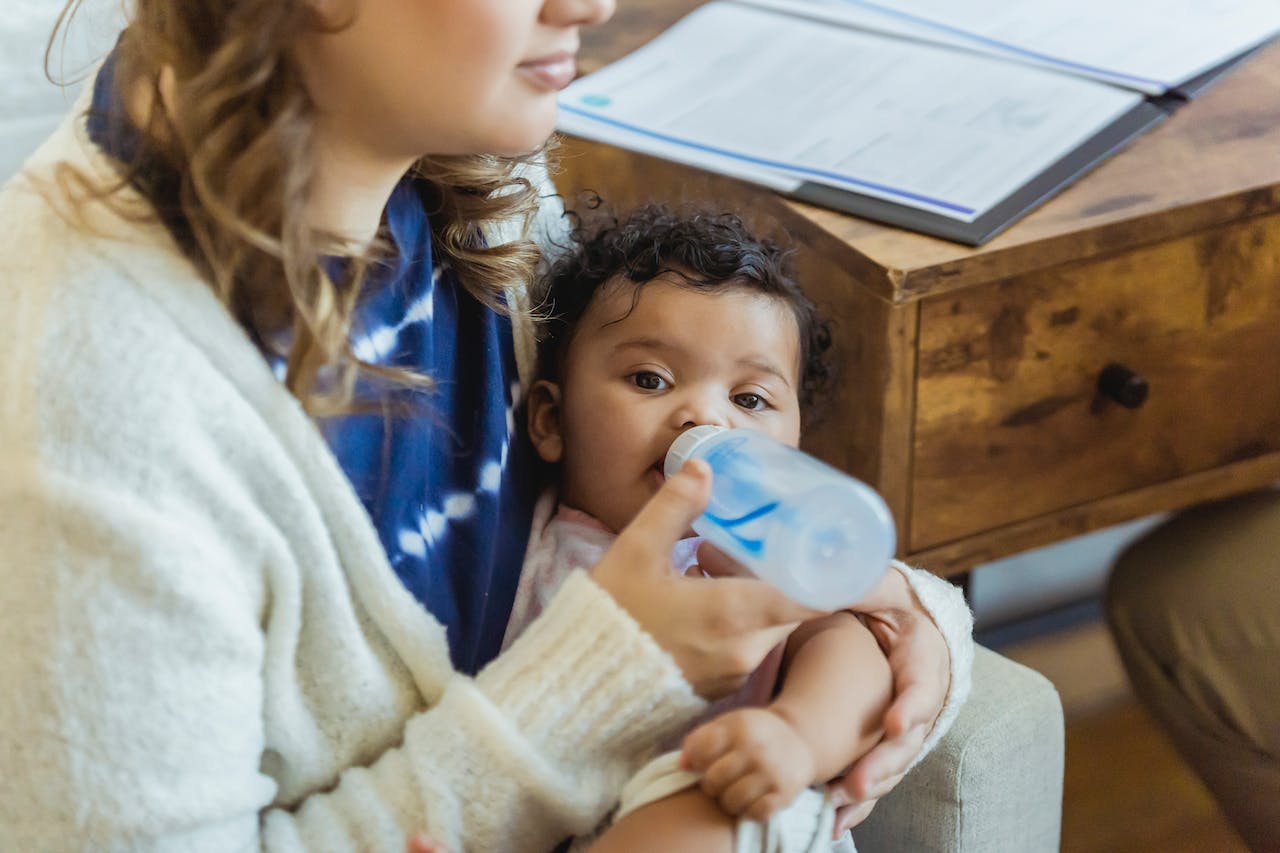 mother feeding baby with a bottle
