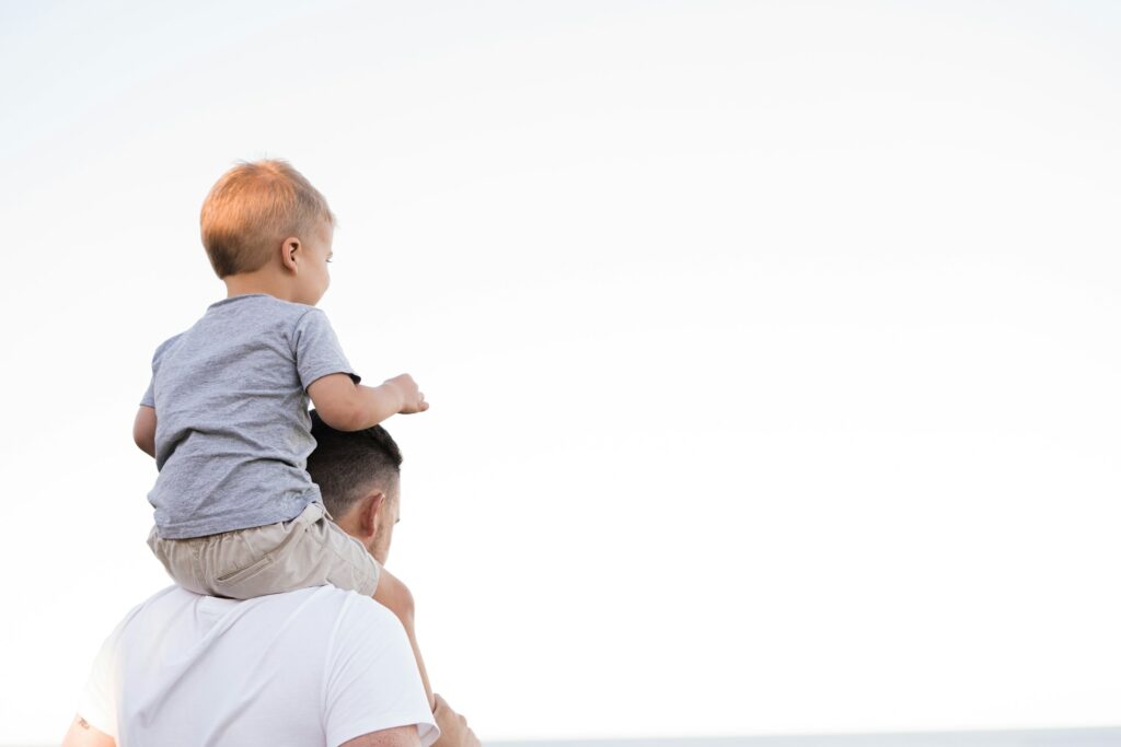child on parents shoulder