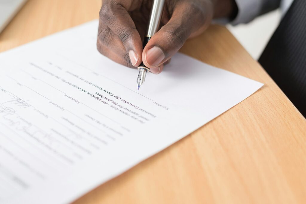 hand signing a legal document
