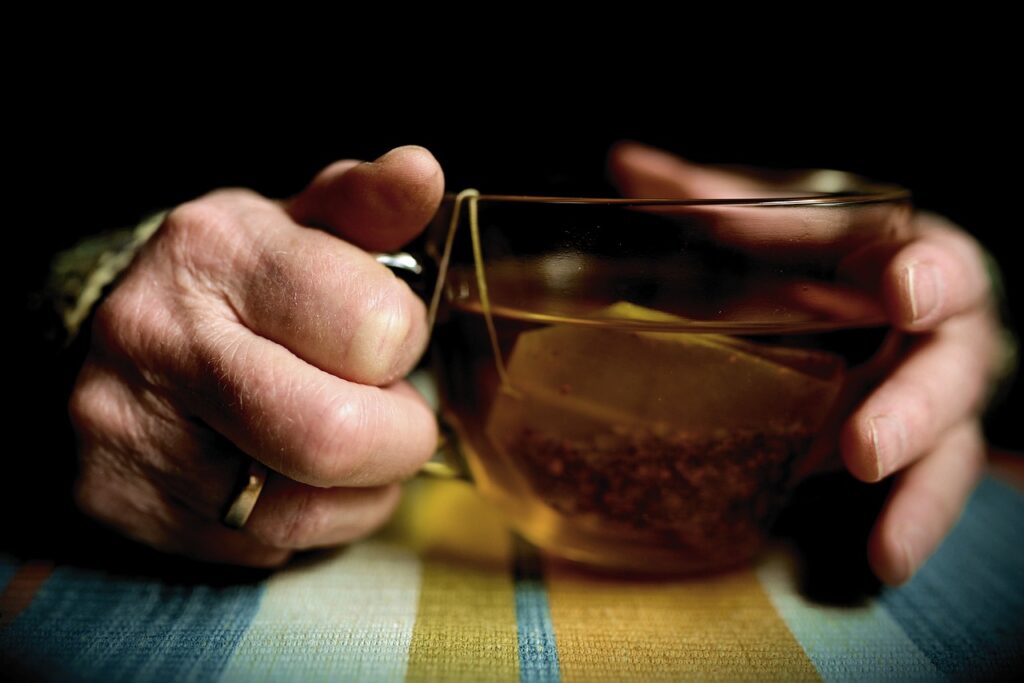 A pair of hands holding a tea cup