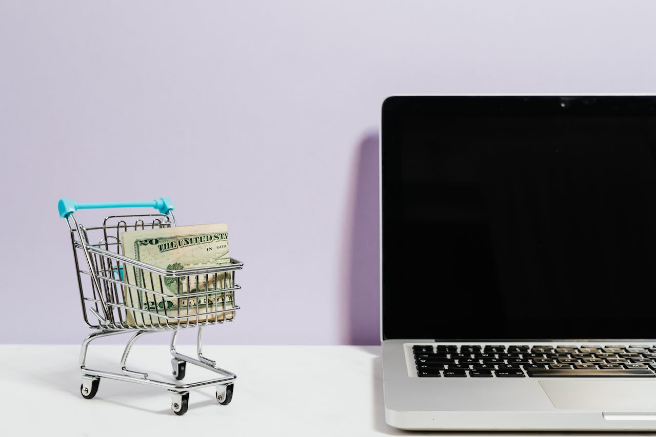 mini shopping trolley near laptop