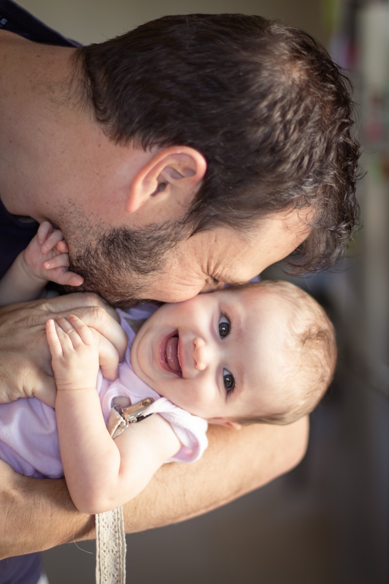 a man holding a baby in his arms - dad morning routine