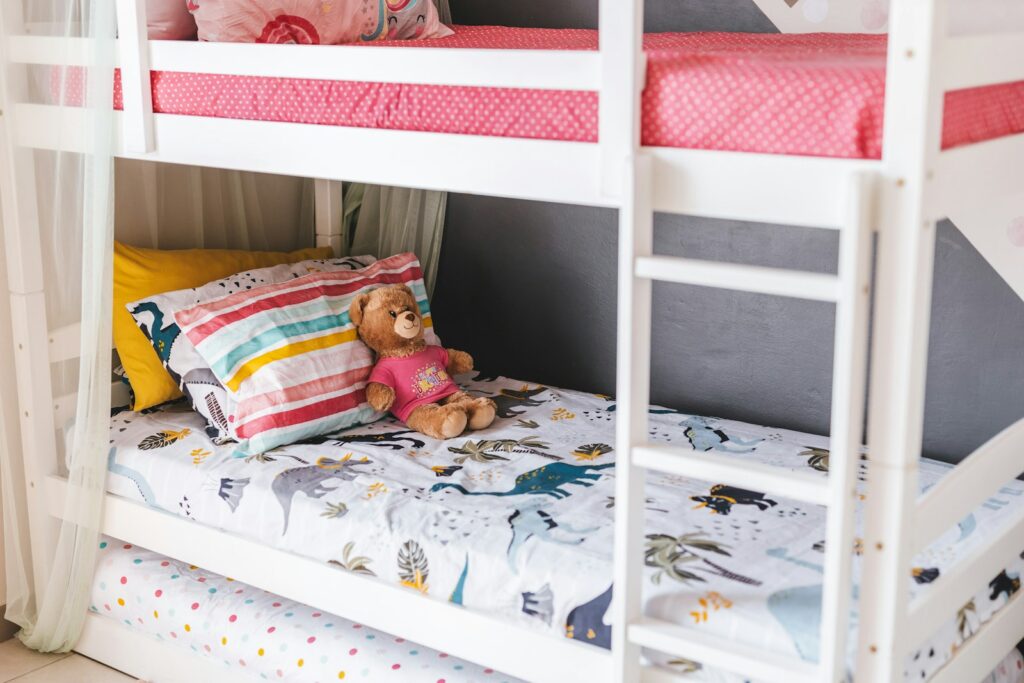 bunk beds with a teddy on the bottom bunk