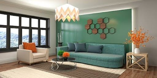 A stylish and airy living room with a green couch and beige armchair