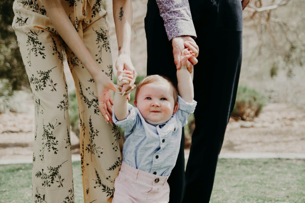baby holding hands and walking
